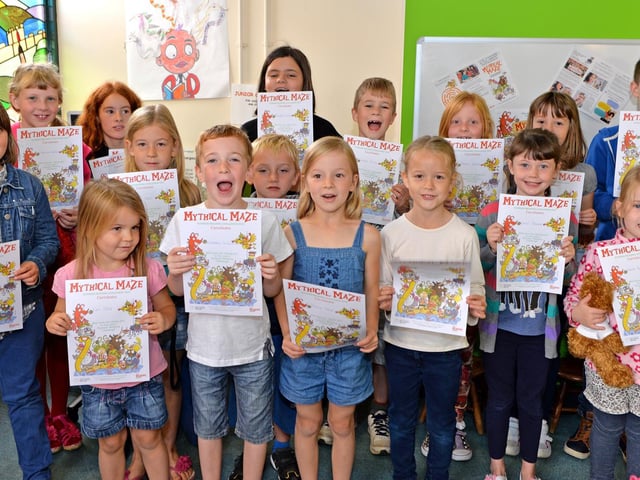 Youngsters receiving their certificates after taking part in Horncastle Libary's Summer Reading Challenge of 2014. That year, the theme for the nationwide event was Mythical Maze. Young bookworms were challenged to read and review six books.