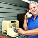 Andy Robinson with one of his antique dial phones. Photos: Mick Fox