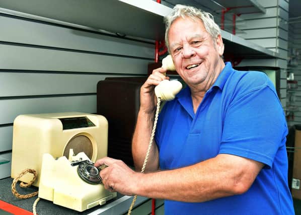 Andy Robinson with one of his antique dial phones. Photos: Mick Fox