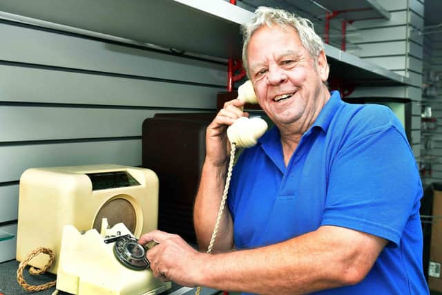 Andy Robinson with one of his antique dial phones. Photos: Mick Fox
