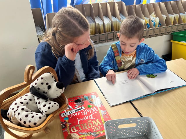 Children practise their reading on World Book Day.