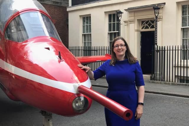 Dr Caroline Johnson with a Red Arrow Hawk jet replica in Downing Street during a showcase event.
