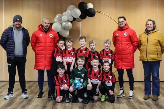 The youngsters of Louth under-sevens pictured with Mark and Sally Westerby in their new kit, provided by the Ken Westerby Memorial Fund.