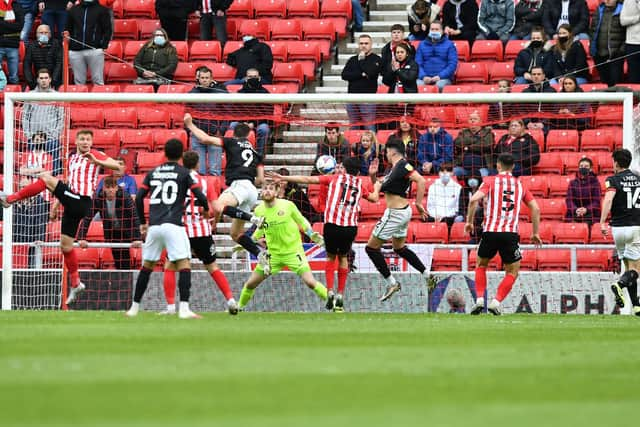 Tom Hopper heads home from a corner for Lincoln City.