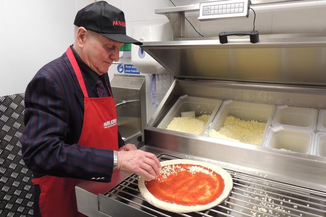 Mayor Coun Anthony Brand has a go at topping his own pizza having opened the new Papa Johns in Sleaford.