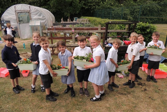 Year 2 pupils at Cranwell School make up flower planters for the school grounds. Photo: AH