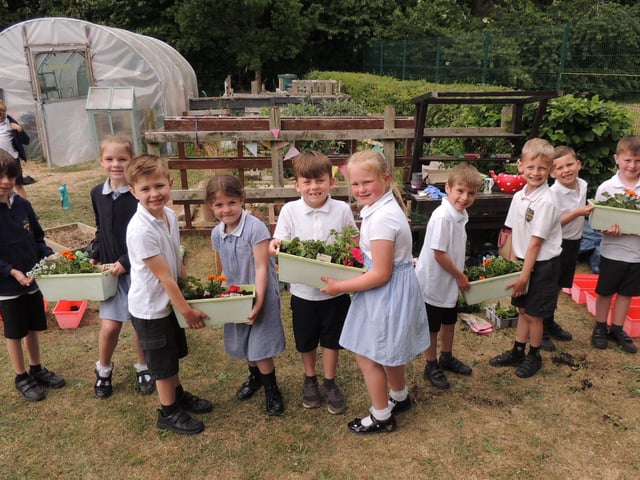 Year 2 pupils at Cranwell School make up flower planters for the school grounds. Photo: AH