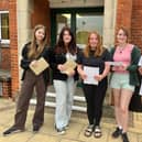 QEGS students with their results, form left: Freya Burgess, Miya Newton, Hope McIlwrick, Gabriella De Cruz, and Lola Poppy.