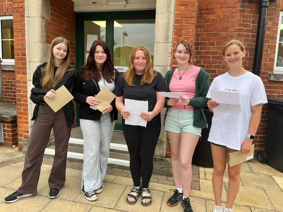 QEGS students with their results, form left: Freya Burgess, Miya Newton, Hope McIlwrick, Gabriella De Cruz, and Lola Poppy.