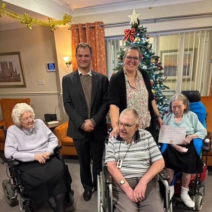 Hamish Falconer, MP for Lincoln and Parliamentary Under-Secretary at the Foreign, Commonwealth and Development Office, with Anna Livsey, Home Manager at HC-One’s Altham Court Care Home and residents
