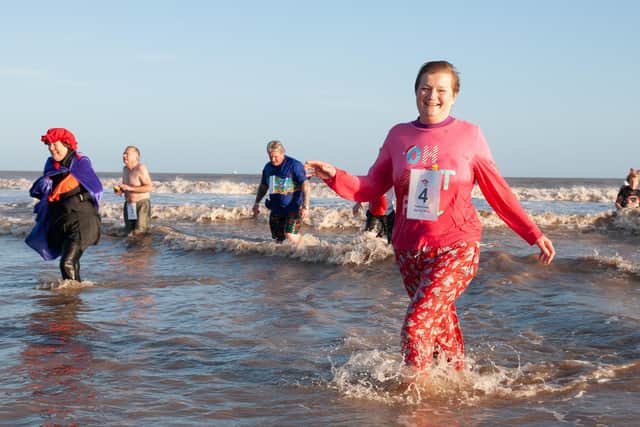 Carol Frisby emerges from the surf on Mablethorpe Beach after taking part in the 2023 Big Dip.