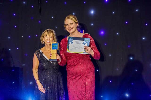 Mags Guest (right) receives award