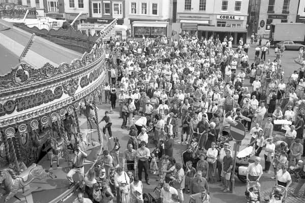 A crowd forms in the Market Place for the opening of the Boston May Fair.