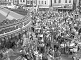 A crowd forms in the Market Place for the opening of the Boston May Fair.