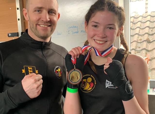 Amber Barry shows off her winners medal after a fine performance on Sunday afternoon.