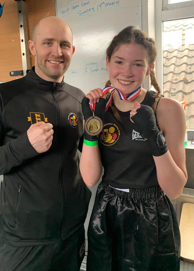 Amber Barry shows off her winners medal after a fine performance on Sunday afternoon.