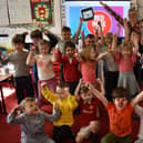 Hands in teh air for Red Nose Day 2024 at Boston's Staniland Academy.