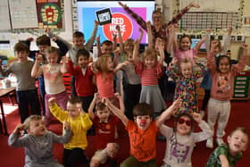 Hands in teh air for Red Nose Day 2024 at Boston's Staniland Academy.