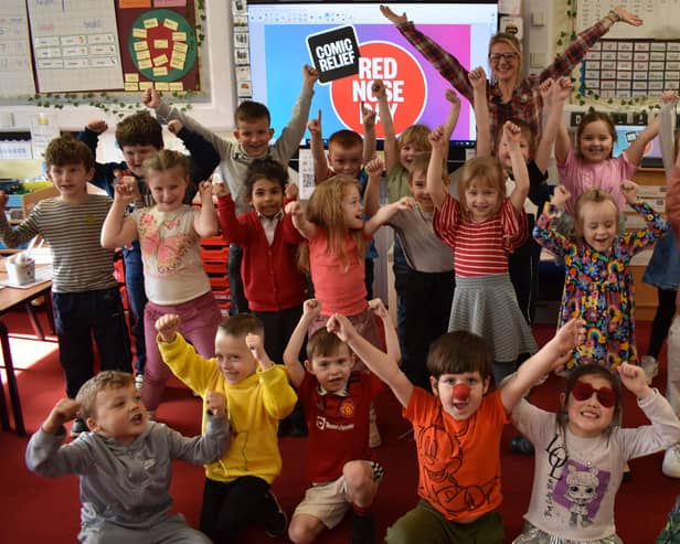 Hands in teh air for Red Nose Day 2024 at Boston's Staniland Academy.