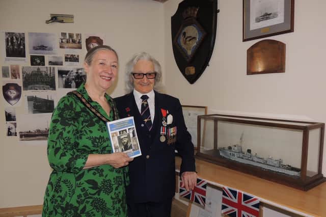 Mayor Coun Linda Edwards-Shea with Alan Harris of the Sleaford branch of the Royal Naval Association with Gerard Clarkin's memoirs and the HMS Sheldrake display.