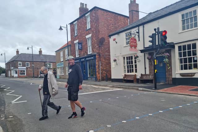 Residents Taha Sabahi and Darren Bailey testing out the new crossing in Burgh le Marsh.