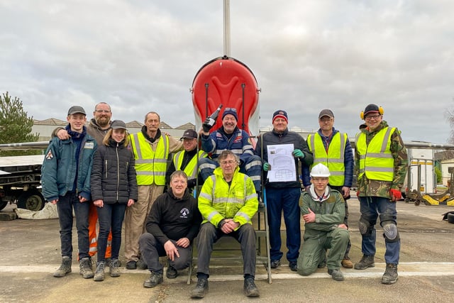 From left: volunteers Cody Giles, Will and Molly Grant Giles,Chris Johnson, Jolyon Andrew Barfield, Josh Mortimer (with Champagne bottle), Andy 'Monty' Burden, Graham Harness and Jon Dean. Front Row: David Smith, Charles Ross (Lightning Association Chairman) and Steve Baker.