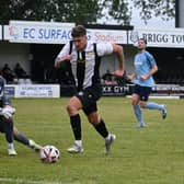 Josh Batty goes round the goalkeeper to score Brigg's third against Barton. Photo: Anna Backstrom/BTFC.