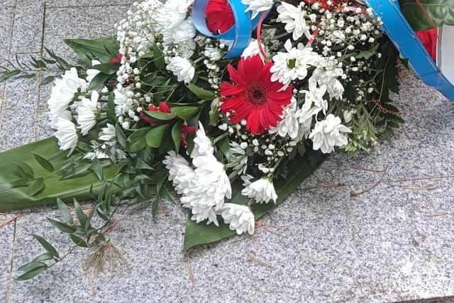 Simon's wreath and floral tribute at the memorial.