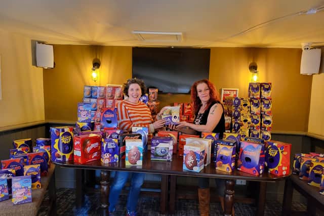 Nikki Thomas (right) presenting Isabel Forrester of the Food Larder with 352 Easter eggs at Easter 2022.