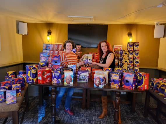 Nikki Thomas (right) presenting Isabel Forrester of the Food Larder with 352 Easter eggs at Easter 2022.