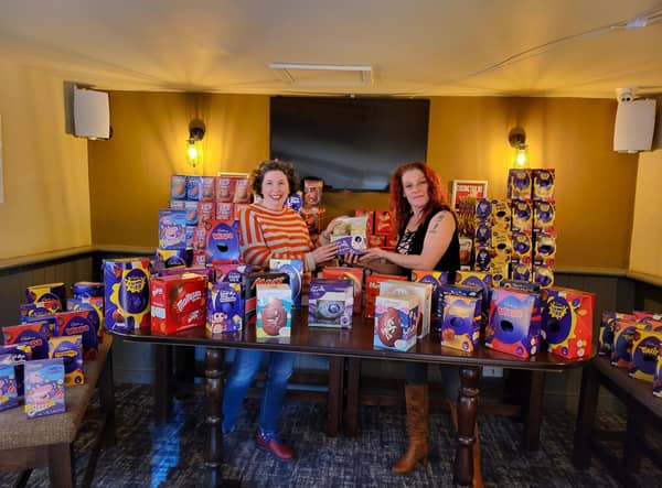Nikki Thomas (right) presenting Isabel Forrester of the Food Larder with 352 Easter eggs at Easter 2022.