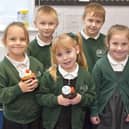 Pupils holding Voyage welcome cakes with Old Leake Primary Academy Headteacher Vicki Hardwick.