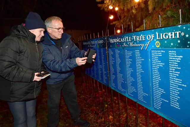 Pete and Gill Crow, of Louth, looking at the list of names at the foot of the Tree Of Light in Horncastle last year. (PHOTO BY: D.R. Dawson Photography)