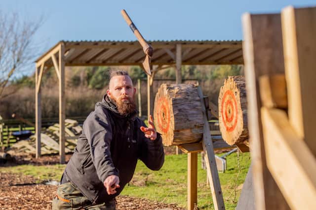 Back 2 Bear's Spencer Kennedy demonstrates axe throwing.