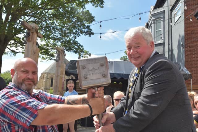 Paul Dixon (left) holding Thor's Hammer with the Mayor of Skegness Coun Pete Barry. Photo: Barry Robinson.