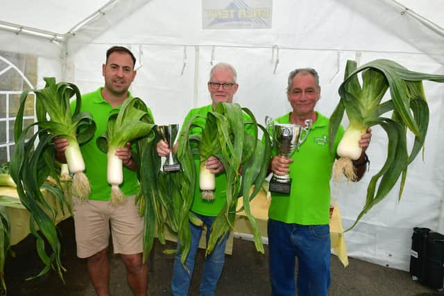 Massive veg held by: L-R Tim Todd (3rd place), Chris Banks (2nd place), Greg Johnson (Winner) at Tetney Leek Club annual show.