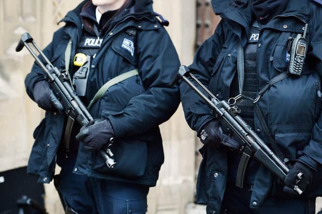 Metropolitan Police firearms officers stand outside the Houses of Parliament in London, as the number of armed officers in Britain's biggest police force will rise by more than a quarter after the Paris terror attacks.