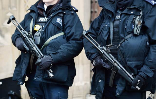 Metropolitan Police firearms officers stand outside the Houses of Parliament in London, as the number of armed officers in Britain's biggest police force will rise by more than a quarter after the Paris terror attacks.
