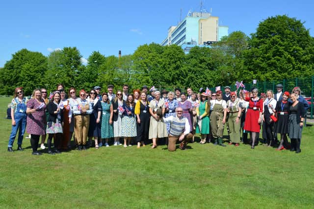 Staff (and some students) in period dress for the street party-style celebration.