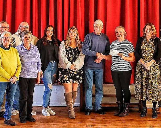 Louth community pantomime club handing over £800 to Hayley Hodson from Mimi's Mission from the proceeds of Robin Hood - The Panto.