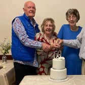 A double diamond wedding celebration. Cutting the cake, from left - John and Patricia Ransome, with Pat and Terry Markham.