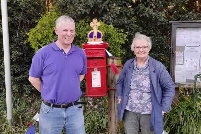 Newly elected Graham Pearson of East Keal Parish Council inspects Heather Naden's creation