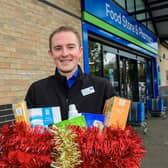 Kristian Varlow, designate store manager, with a decorated collection box