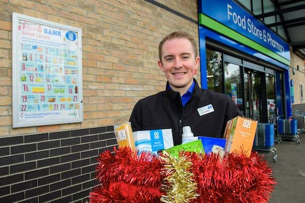 Kristian Varlow, designate store manager, with a decorated collection box