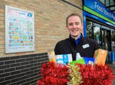 Kristian Varlow, designate store manager, with a decorated collection box