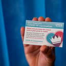You receive a card to show you have been vaccinated (Photo by Jack Hill / POOL / AFP) (Photo by JACK HILL/POOL/AFP via Getty Images)