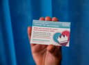 You receive a card to show you have been vaccinated (Photo by Jack Hill / POOL / AFP) (Photo by JACK HILL/POOL/AFP via Getty Images)