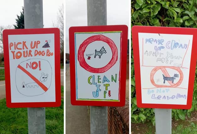 Three of the winning poster designs, now in place as metal signs.