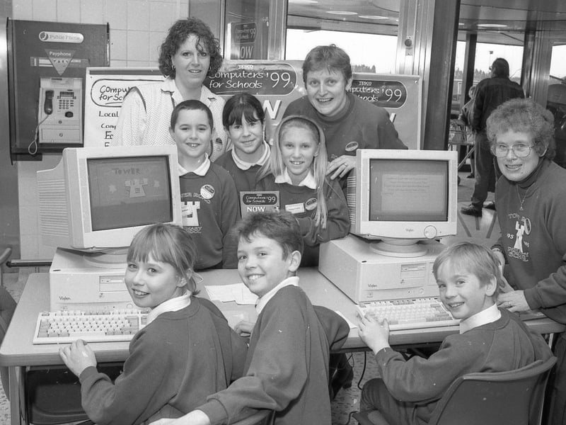 Another picture of pupils from Boston's Tower Road Primary School. The school was one of the many in the Boston area that had been taking part in schemes run by supermarkets to provide computers for the classroom. Pupils Sarah Peak, Adam Reece, Emma Corby, Mike Platt, Holly Carter and Nicky Kirkham were invited to take a couple of their school's machines bought through the Tesco scheme back to the store for the launch of Computers for Schools '99.