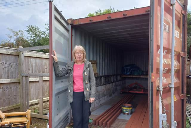 CEO and charity founder Pam Hodge at the empty storage container. Items estimated to total £20,000 were stolen last week. Image: Dianne Tuckett